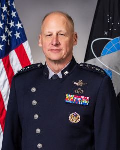 General Michael Guetlein, Trump's pick to lead Golden Dome efforts, poses for a portrait in front of two flags.