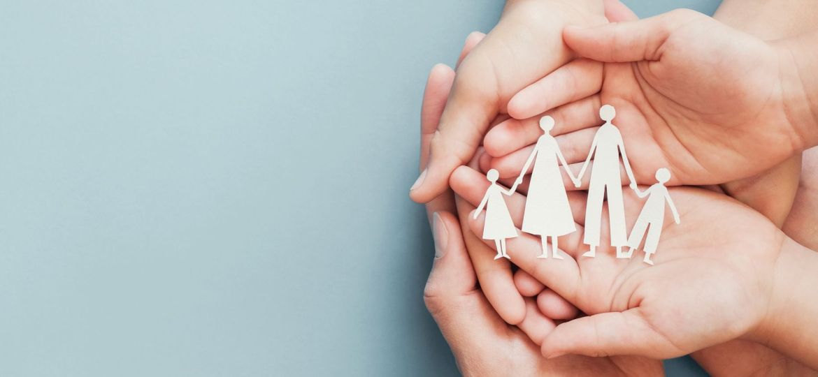 Adult and children hands holding paper family cutout, family home, foster care, homeless charity support concept, family mental health, budgeting during recession concept
